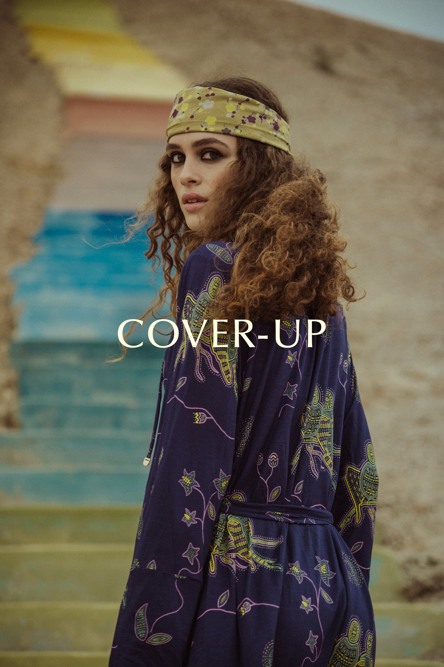 Cover up presentation with a girl wearing a dark blue floating kimono called Tuyo from the Noodle Beachwear 2025 collection, Noodle Mirage
